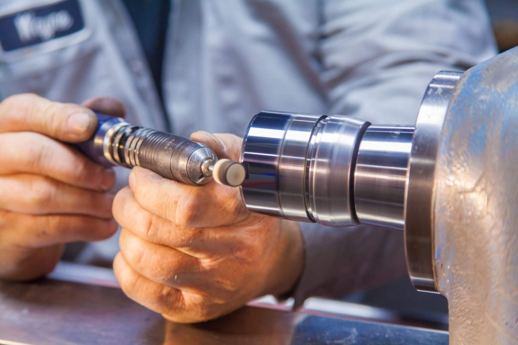 A man mechanically polishing a tool